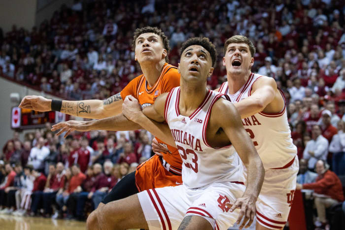 Indiana Hoosiers forward Trayce Jackson-Davis (23) and forward Miller Kopp (12) box out Illinois Fighting Illini forward Coleman Hawkins (33).